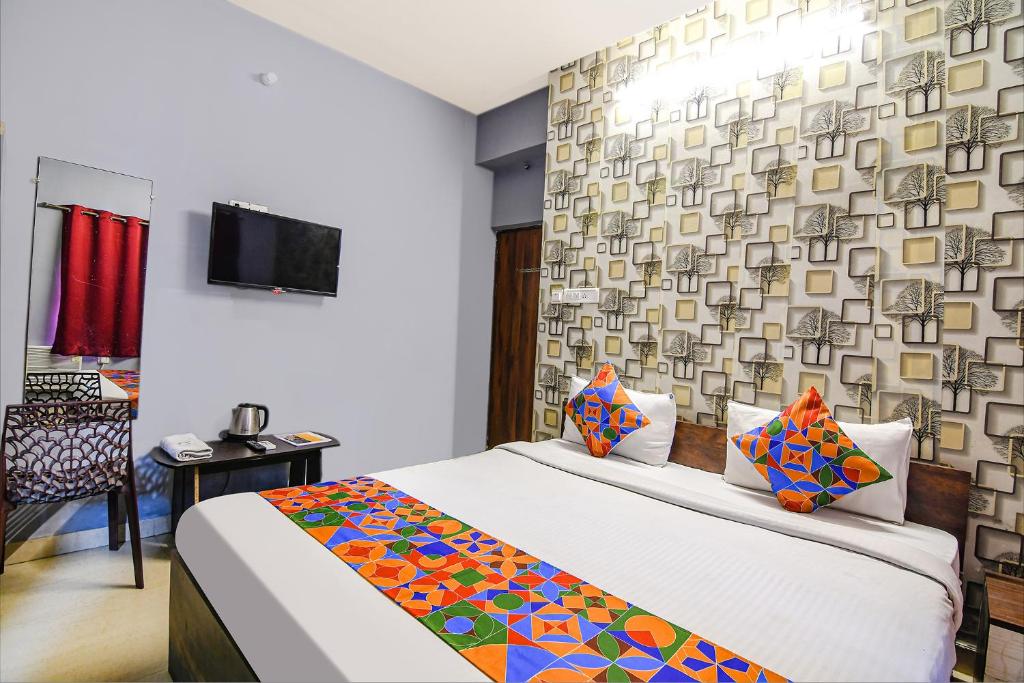 a hotel room with a bed and a tv at FabExpress Westin Palaza in kolkata