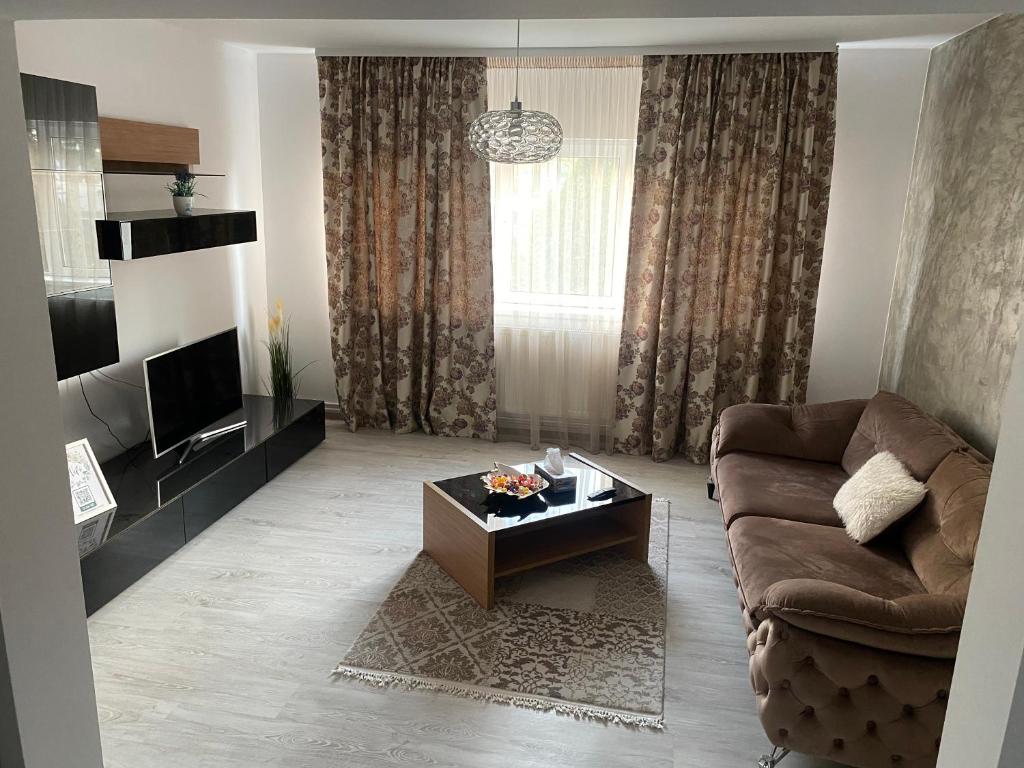 a living room with a couch and a coffee table at Apartament SUN in Drăgăşani