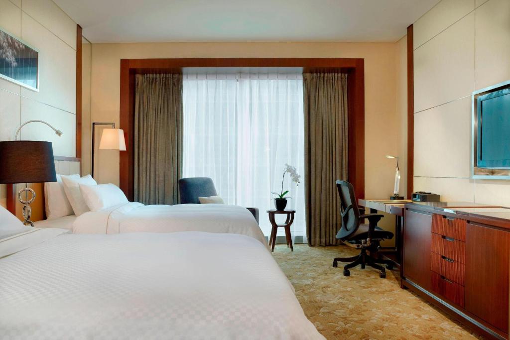 Postel nebo postele na pokoji v ubytování The Westin Tianjin