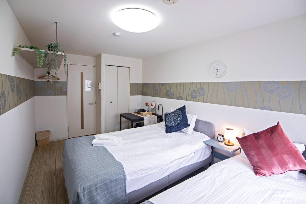 Kiyomizu Sannenzaka Home in Kyoto - Vacation STAY 34439v tesisinde bir odada yatak veya yataklar