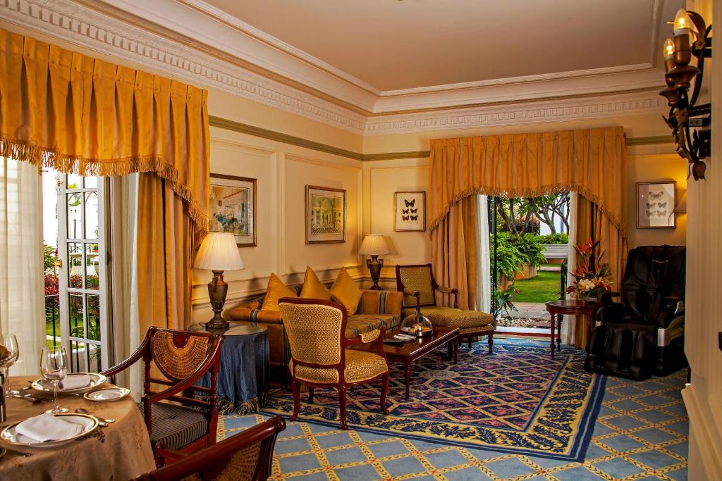 a living room with a couch and a table at ITC Windsor, a Luxury Collection Hotel, Bengaluru in Bengaluru