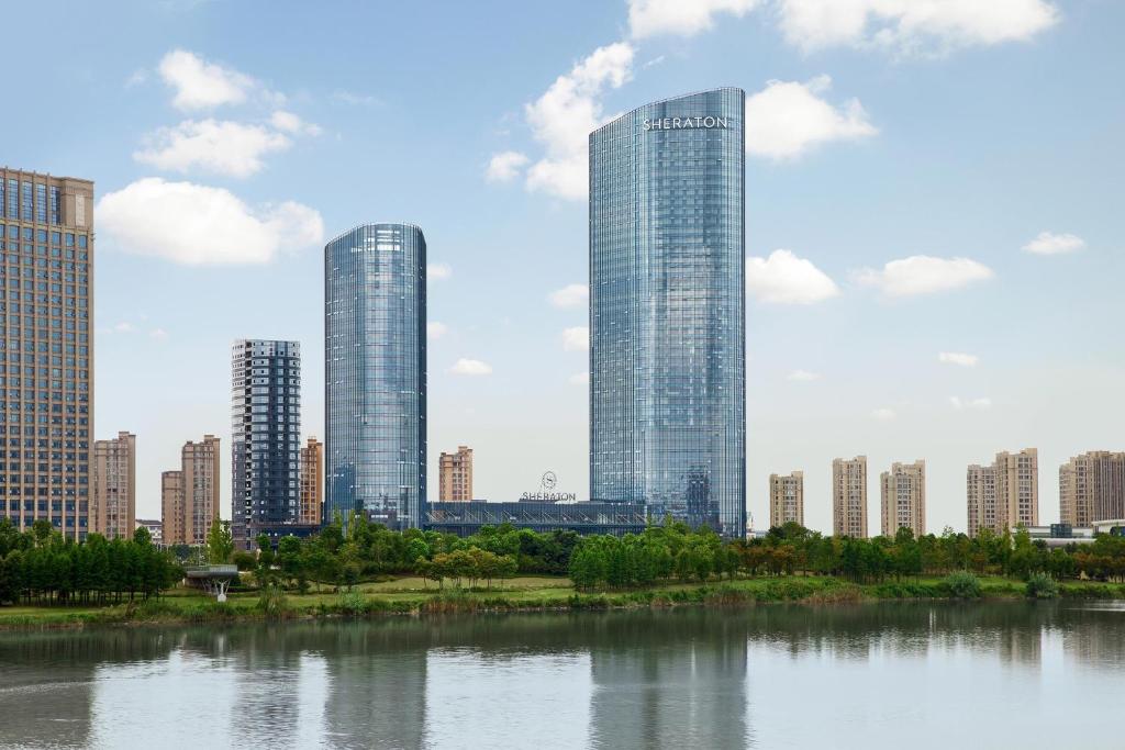 a city skyline with tall buildings and a body of water at Sheraton Shaoxing Shangyu in Shaoxing