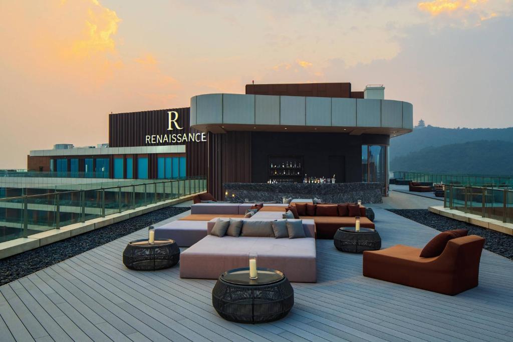 a building with couches and tables on a roof at Renaissance Suzhou Taihu Lake Hotel in Suzhou