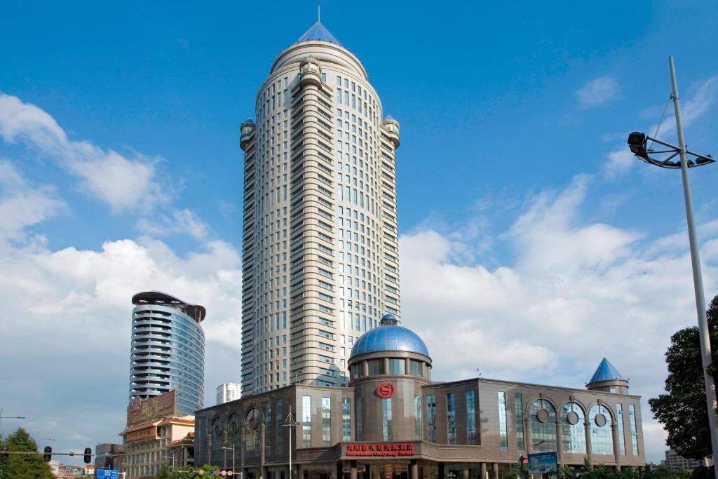 a large building with a tall skyscraper at Sheraton Guiyang Hotel in Guiyang