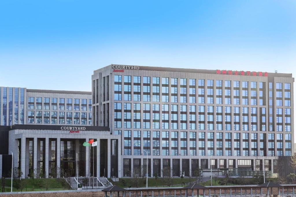 a large office building with a lot of windows at Courtyard by Marriott Zhengzhou Airport in Zhengzhou