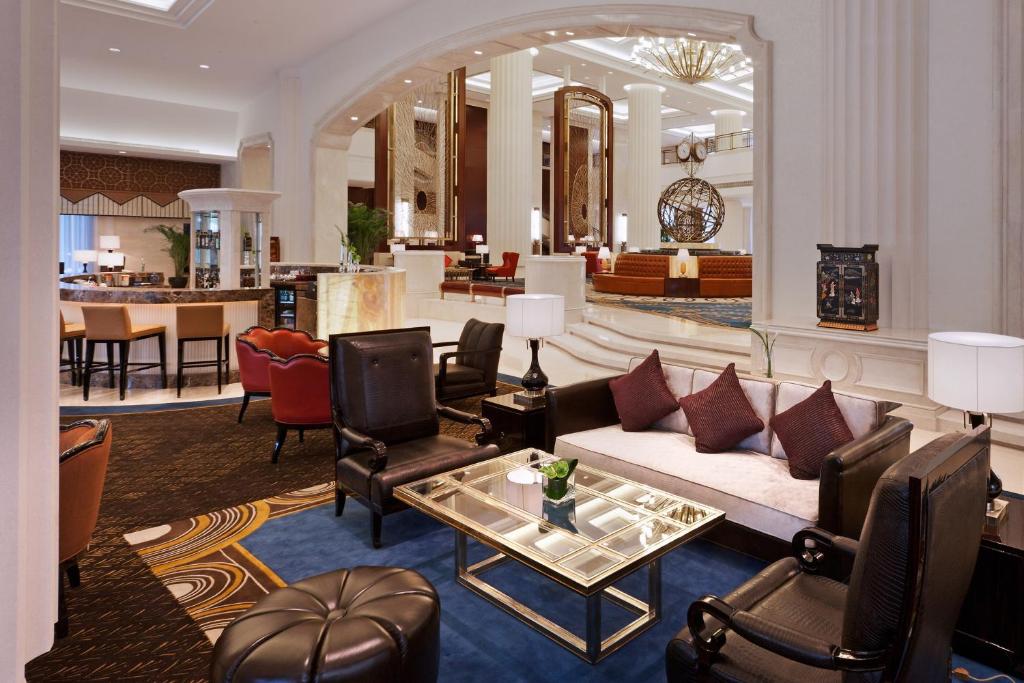 a lobby with a couch and chairs and a table at Sheraton Changzhou Wujin Hotel in Changzhou