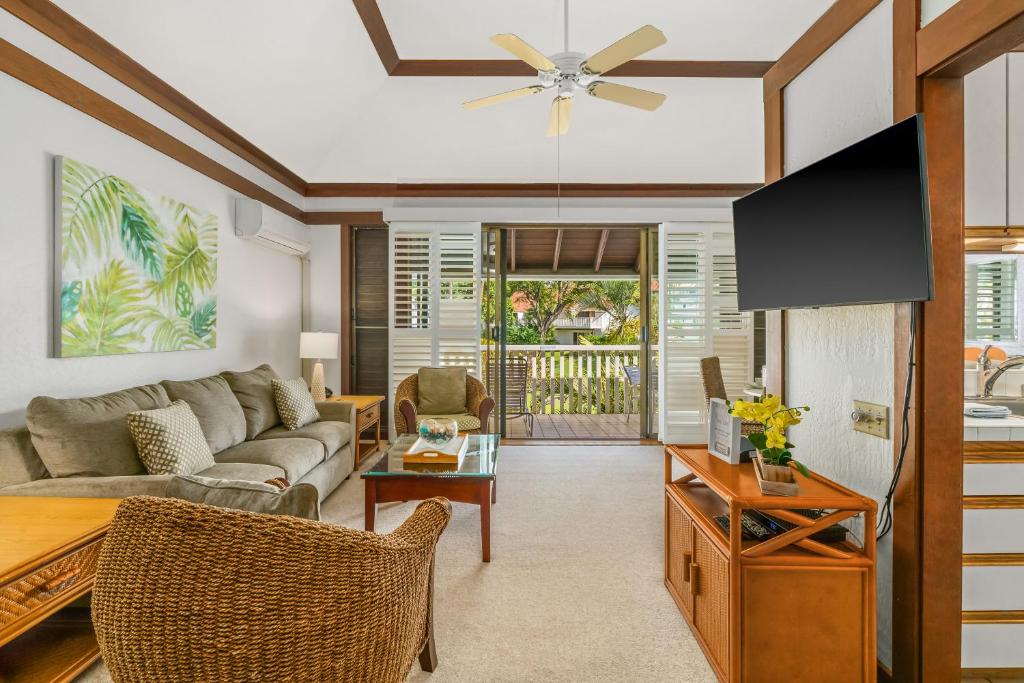 a living room with a couch and a table at KP41 1Br Poipu Condo with AC, Steps to the Beach in Koloa
