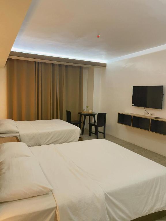 Postel nebo postele na pokoji v ubytování Soleo Inn