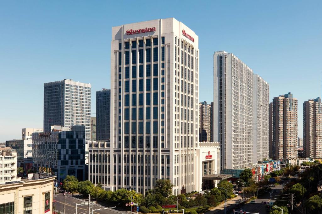 a tall white building with a santana sign on it at Sheraton Zhenjiang Hotel in Zhenjiang