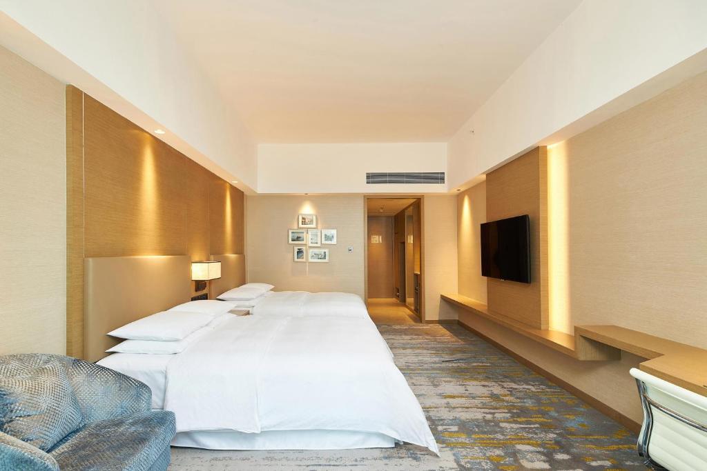 Postel nebo postele na pokoji v ubytování Four Points by Sheraton Jiaxing