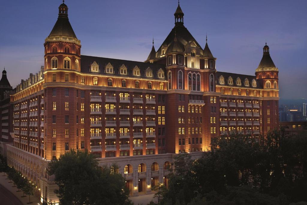 a large building lit up at night at The Ritz-Carlton, Tianjin in Tianjin