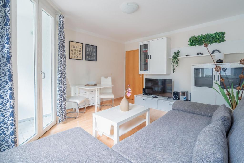 a living room with a couch and a table at City Park Apartments - #11-12 - Apartments mit Ambiente am Park in Leipzig