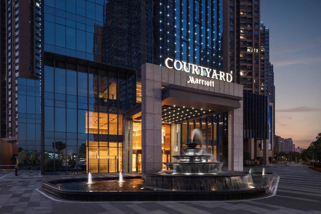 a building with a fountain in front of it at Courtyard by Marriott Shenzhen Bao'an in Bao'an