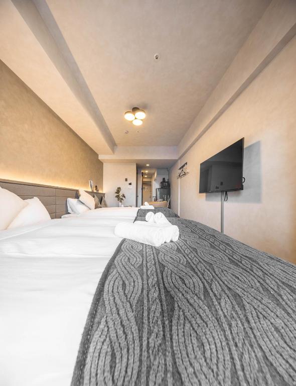 Postel nebo postele na pokoji v ubytování Apartment Hotel 11 Shinsaibashi 2