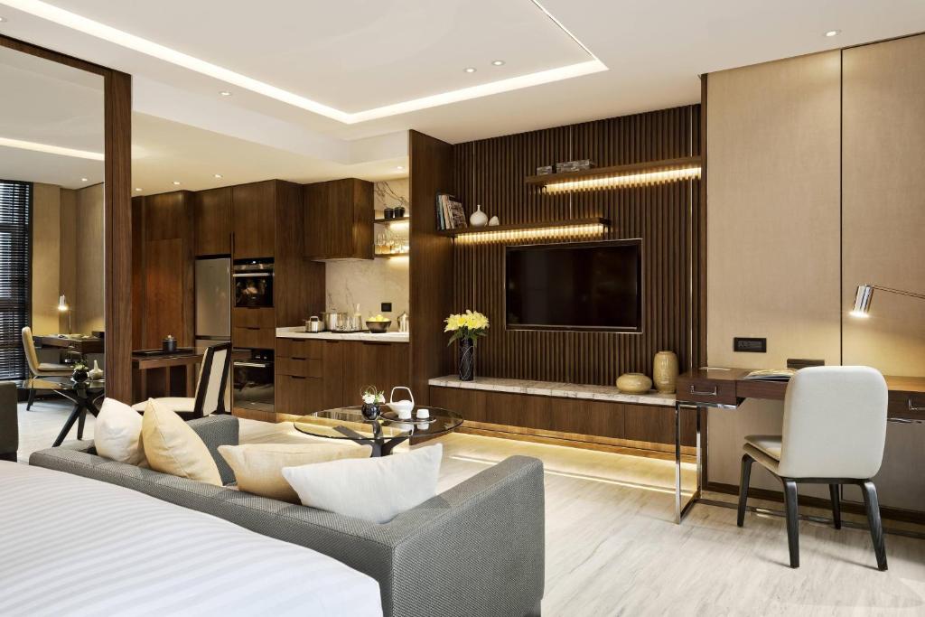 a bedroom with a bed and a living room at The Fairway Place, Xi'an - Marriott Executive Apartments in Xi'an