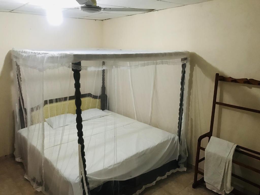 1 cama con dosel en una habitación en Senani Villa, en Hungama