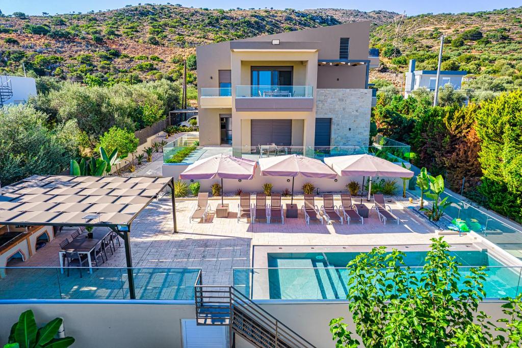 an aerial view of a villa with a swimming pool at Chris apartment with private ecologic pool and kid's playground! in Chania