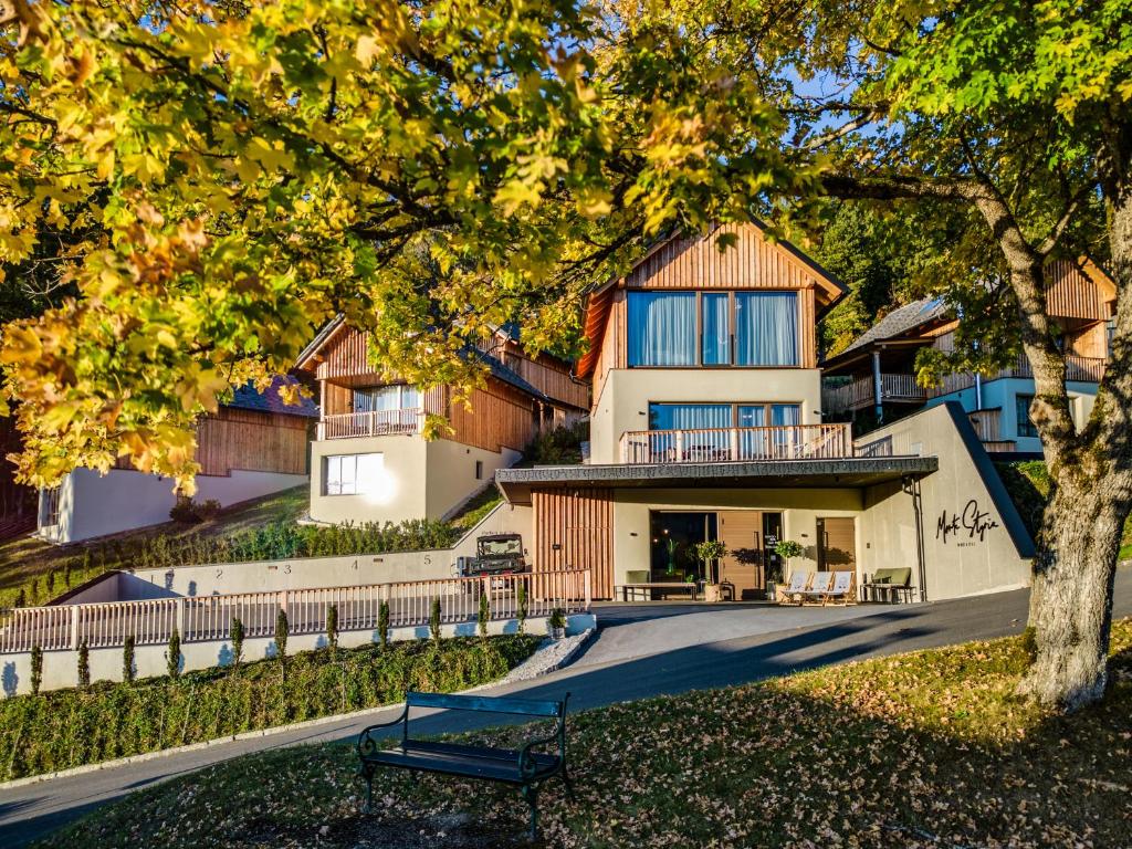 a house with a bench in front of it at Hideaway Hotel Montestyria Chalets & Suiten in Mariazell