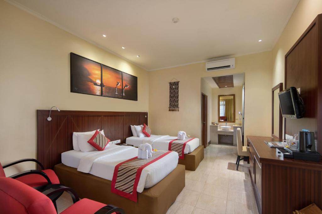 Tempat tidur dalam kamar di Grand Istana Rama Hotel