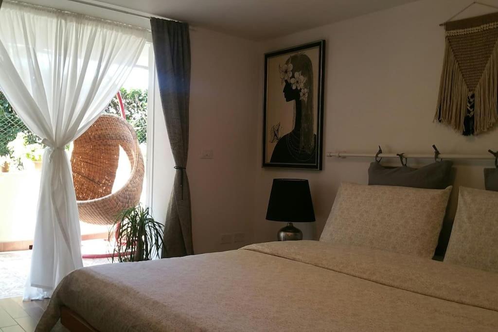 a bedroom with a bed and a window at Cristina’s flat Riccione in Riccione