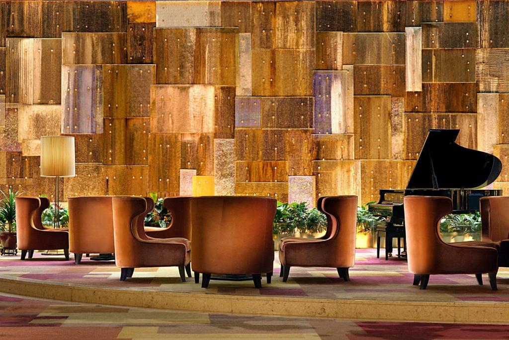 a lobby with chairs and a wall of wood at Sheraton Ningbo Hotel - Tianyi Square in Ningbo