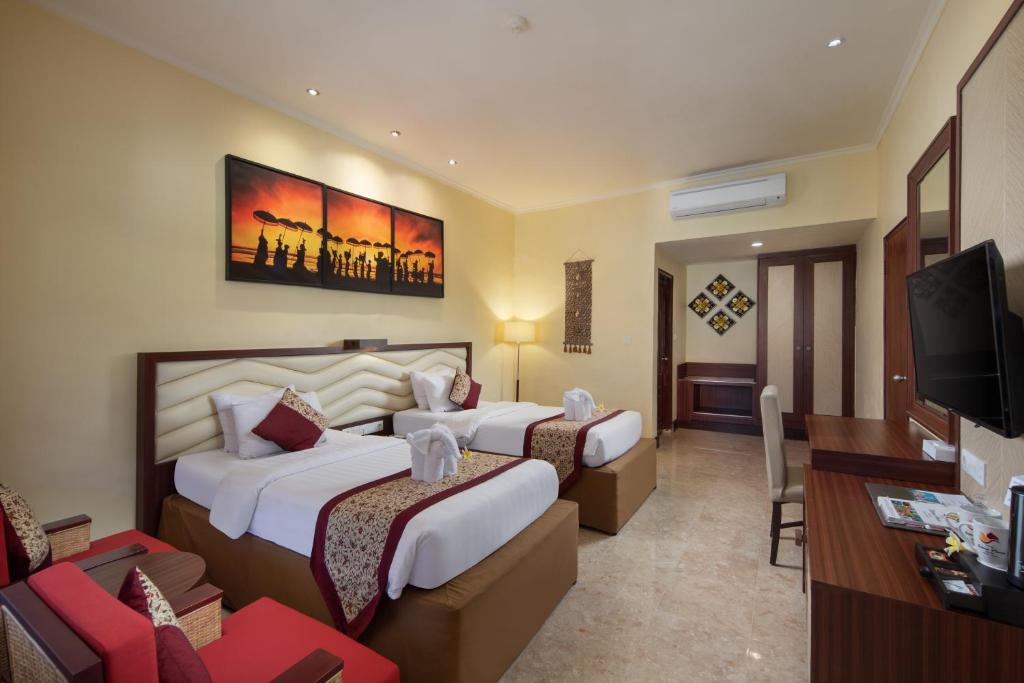 Tempat tidur dalam kamar di Grand Istana Rama Hotel