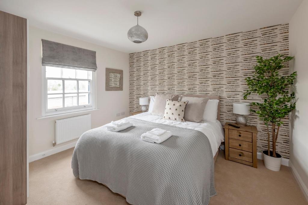 a bedroom with a white bed and a window at 1 Victoria Place in Bath