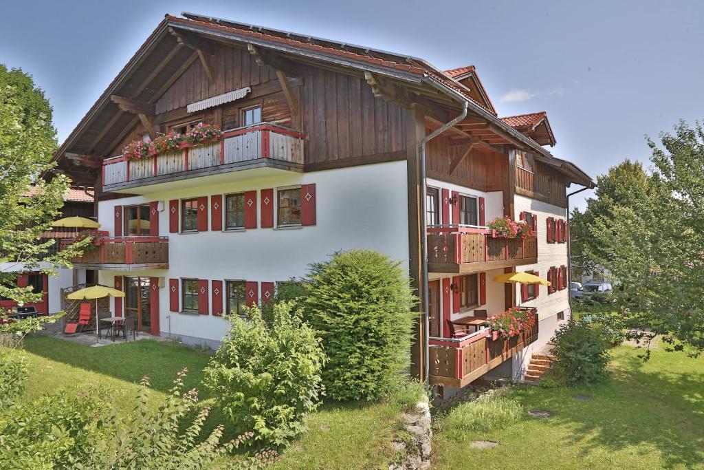 a building with balconies on the side of it at Alpenstern Finy, Bio-Gästehaus in Oy-Mittelberg