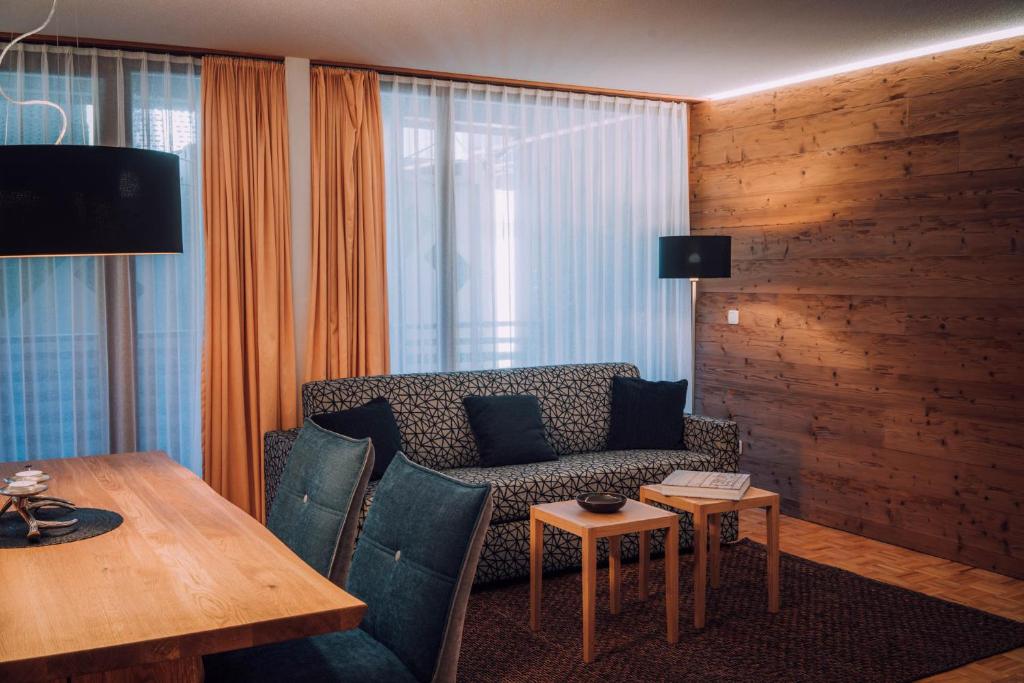 a living room with a couch and a table at Apartment Auenfeld in Schröcken