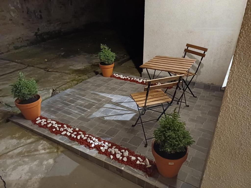 a patio with a table and two chairs and flowers at BelDor Apartment in Belgrade