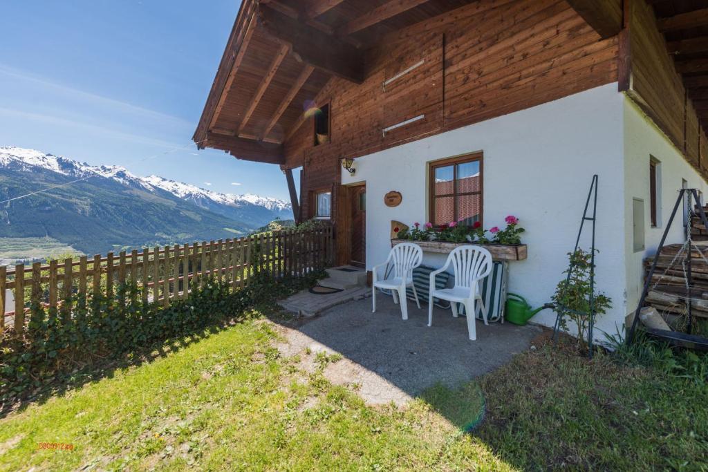 a table and chairs on the side of a house at Almliesl HOLL-154 in Hollersbach im Pinzgau