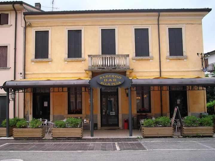 a yellow building with a balcony on top of it at Destiny rooms valpolicella in Pedemonte