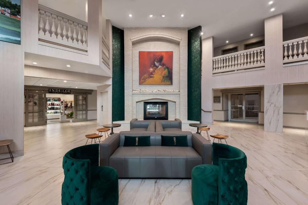 a lobby with a couch and a fireplace at Wyndham Garden Galena Hotel & Day Spa in Galena