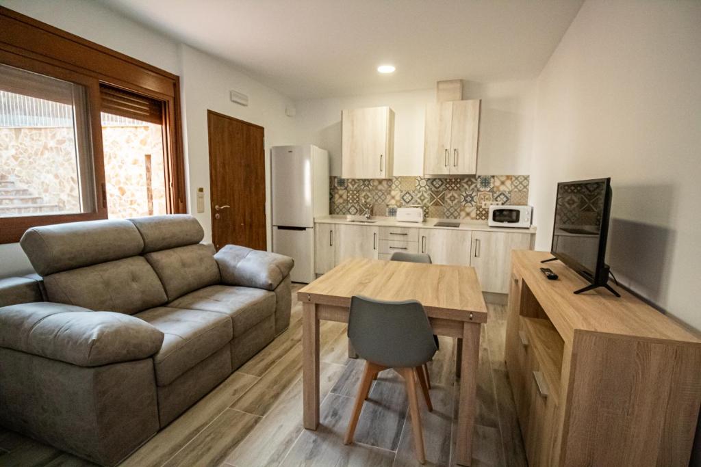 a living room with a couch and a table at Apartamentos 7 puentes sierra Cazorla Casa Tejo in Burunchel