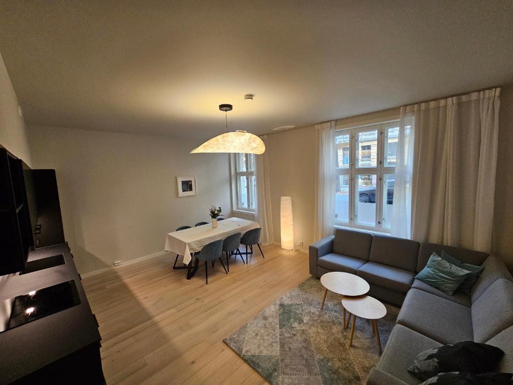 a living room with a couch and a table at Apartment with Balcony in Erling Skjalgssons in Oslo