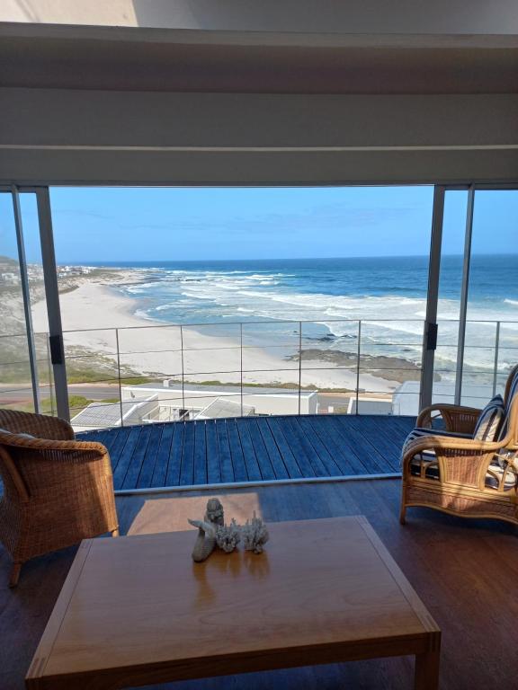 a living room with a view of the ocean at Swept Away Guesthouse - No-Loadshedding in Yzerfontein