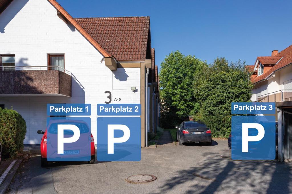 a car parked in a parking lot next to a house at Sonnendeck 1 in Bad Arolsen