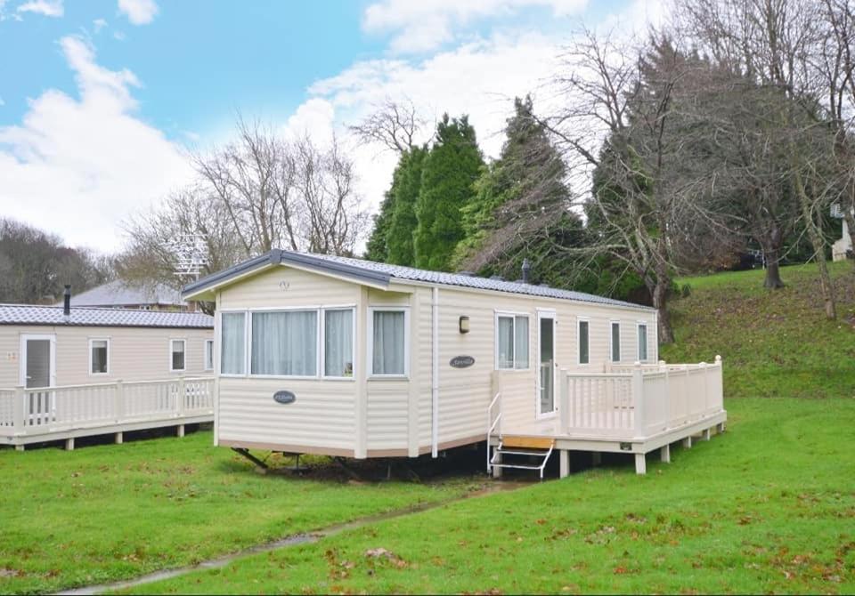 a large white caravan on a grass field at KINSGATE 2 in Shanklin