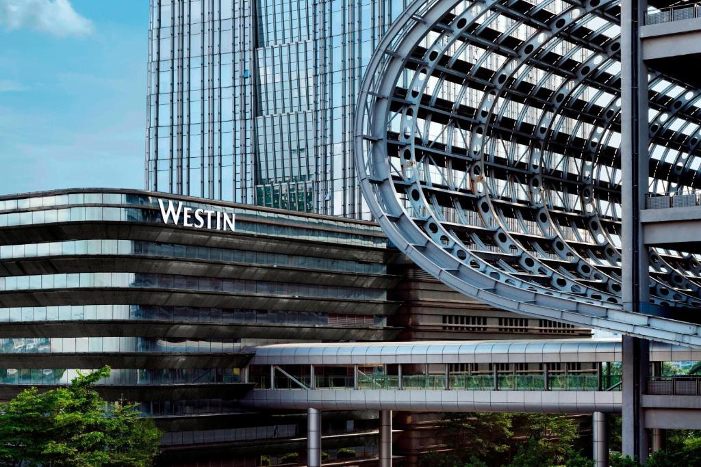 a tall building with a sign in front of it at The Westin Pazhou in Guangzhou