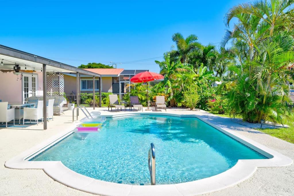 a swimming pool in the backyard of a house at Cozy 60's home, city & canal located in Cape Coral