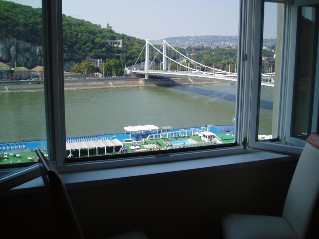 a window with a view of a river and a bridge at Danube View in Budapest