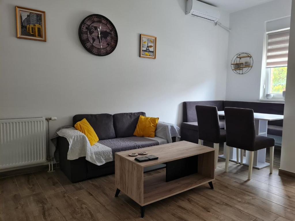 uma sala de estar com um sofá e uma mesa em KARIBO apartman 3 em Sombor