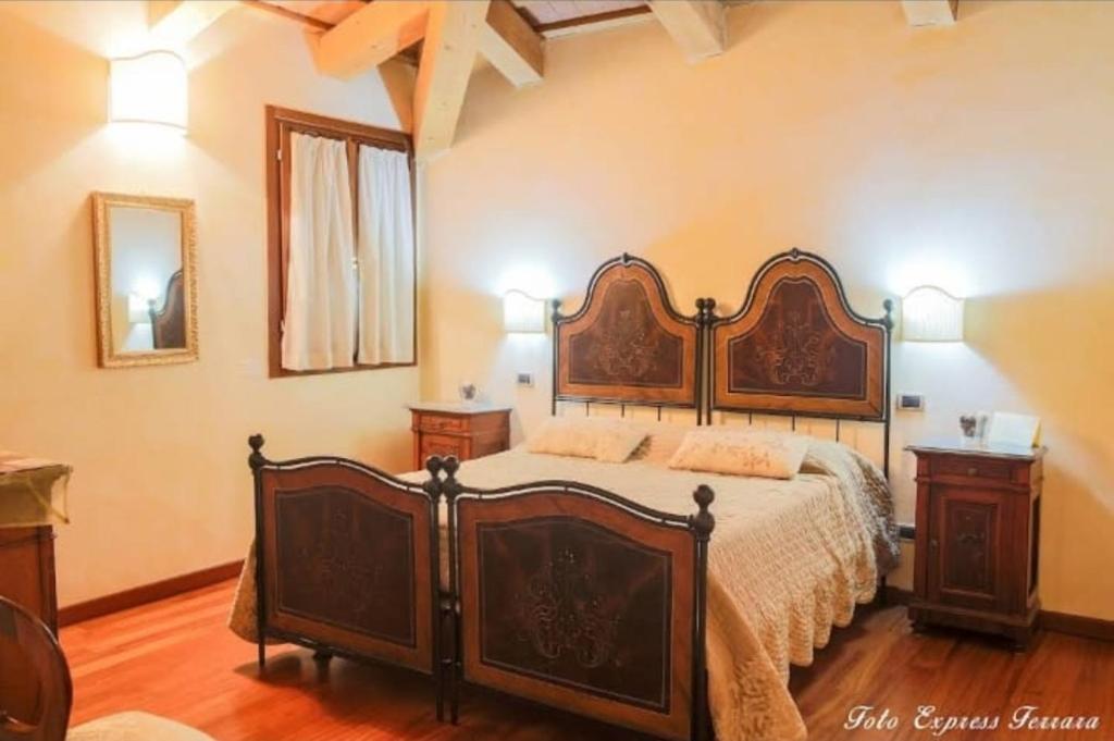 a bedroom with a large bed and two night stands at IL FAGIANO in Sette Polesini