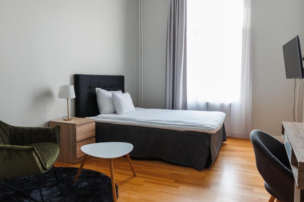 Postel nebo postele na pokoji v ubytování Piteå Stadshotell
