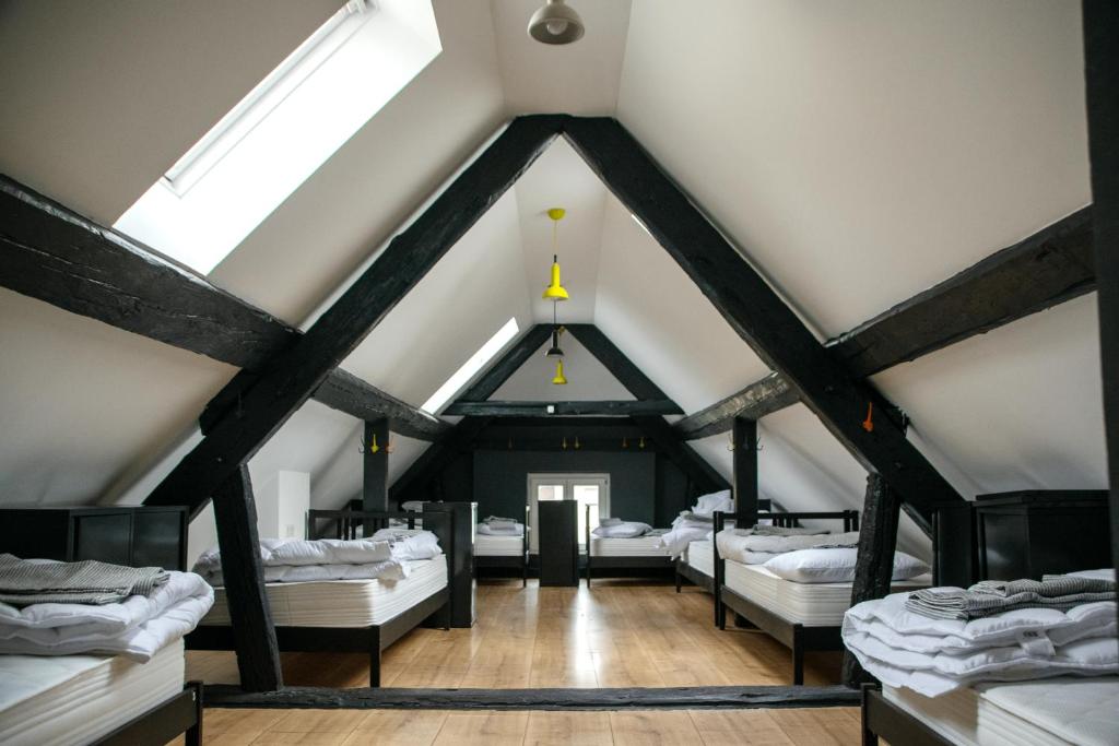 a attic room with a bunch of beds at Sax Pub Hostel Ljubljana in Ljubljana