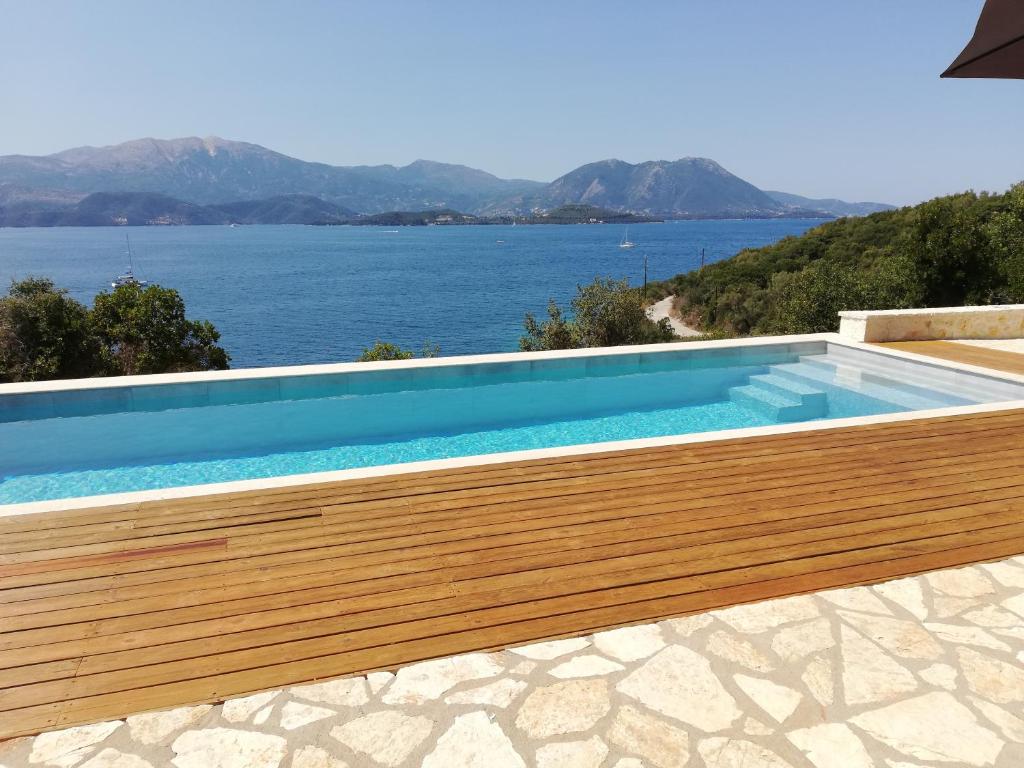 a swimming pool with a view of the water at Villa VaKo in Vathí