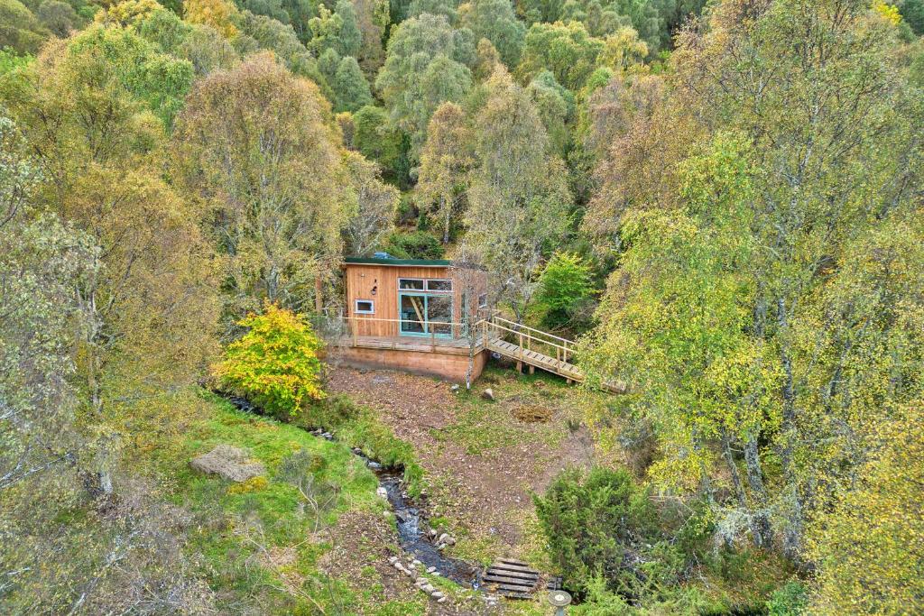 an aerial view of a cabin in the middle of a forest at Finest Retreats - Cosagach Falls Cabin in Kiltarlty
