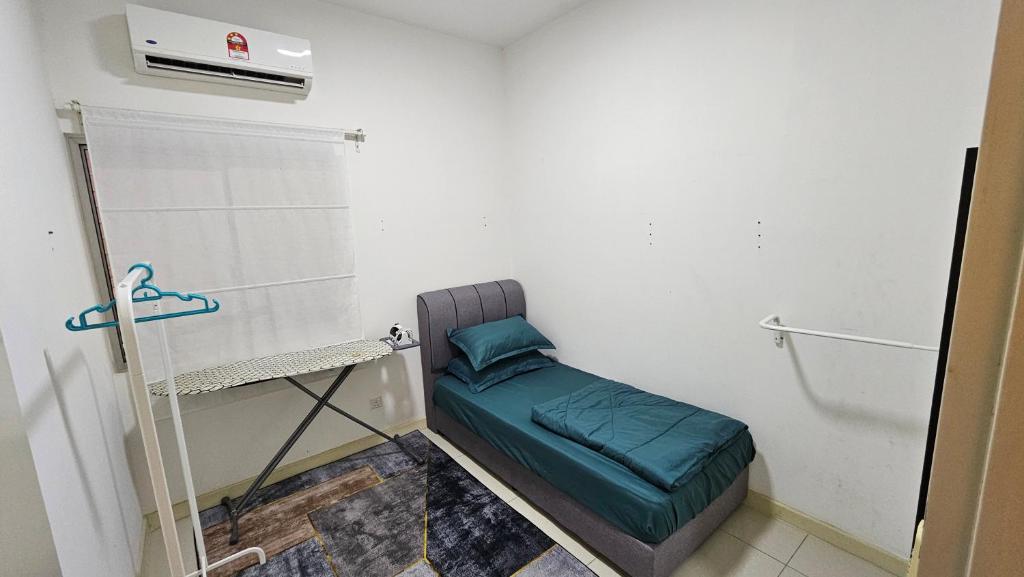 a small room with a bed and a heater at Serenestay Cozy Studio @ Southville City in Kajang