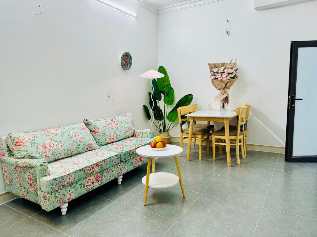 a living room with a couch and a table at Local Me - Exclusive Centre Room in Hai Phong