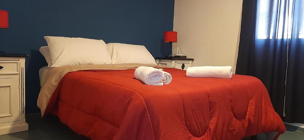 a bedroom with a bed with two towels on it at Departamentos MAWER in El Calafate